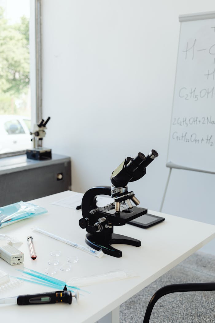A well-equipped laboratory with a microscope and lab supplies on the table.